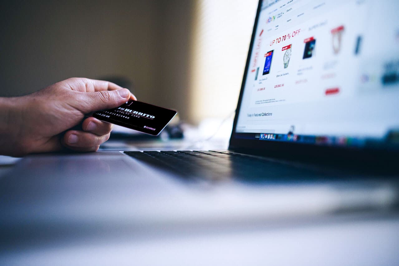 E-commerce specialist working with laptop and credit card